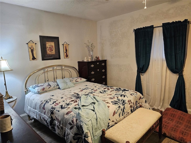 bedroom with dark wood-type flooring