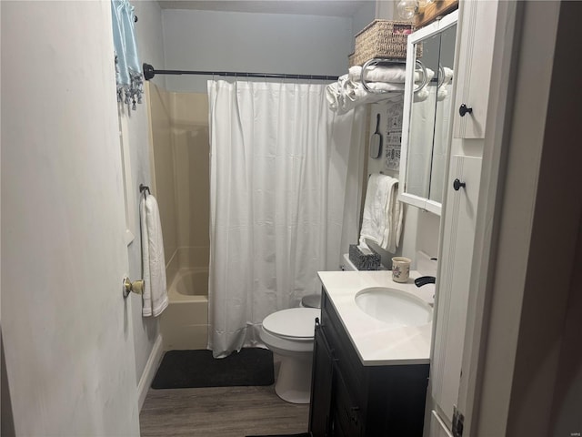 full bathroom with hardwood / wood-style flooring, vanity, toilet, and shower / bath combo with shower curtain