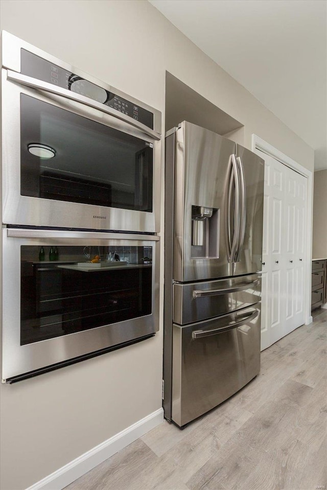 kitchen featuring light wood-type flooring and stainless steel appliances