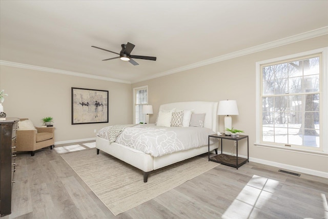 bedroom with ceiling fan, light wood-type flooring, and crown molding