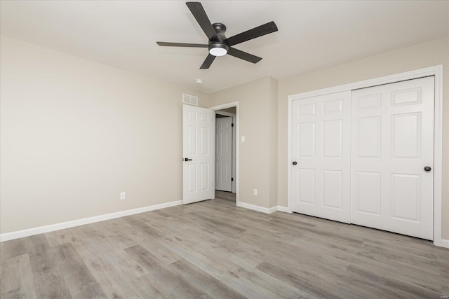 unfurnished bedroom featuring ceiling fan, a closet, and light hardwood / wood-style floors