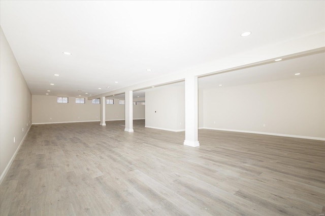 basement with light hardwood / wood-style flooring