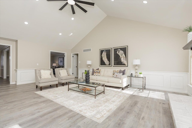 living room featuring high vaulted ceiling, light hardwood / wood-style flooring, and ceiling fan