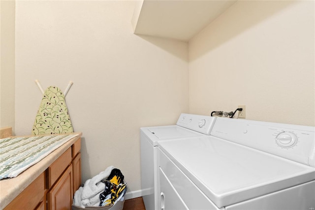 washroom with washer and clothes dryer and cabinets