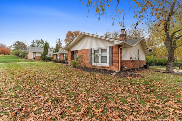 view of property exterior with a yard and central AC unit