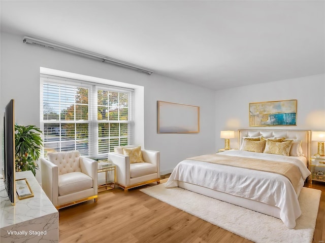 bedroom with light hardwood / wood-style floors