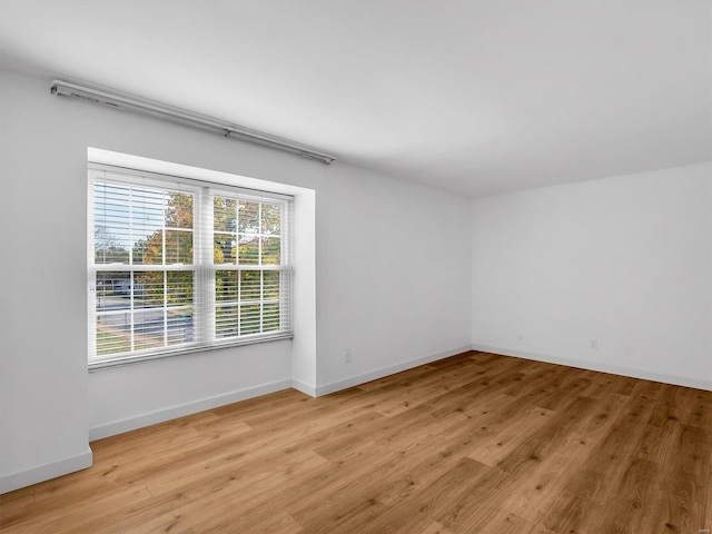 unfurnished room with plenty of natural light and light hardwood / wood-style flooring