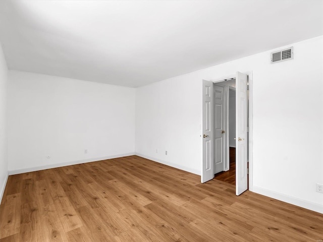 spare room with light hardwood / wood-style flooring