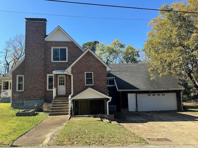 view of front property featuring a garage and a front lawn