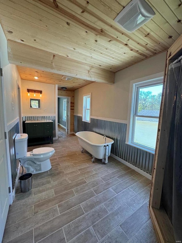 bathroom featuring a bathing tub, hardwood / wood-style flooring, toilet, and wooden ceiling