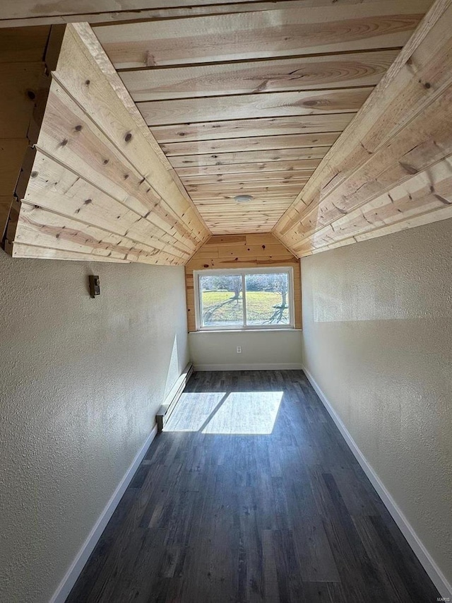 additional living space featuring lofted ceiling, wooden ceiling, dark hardwood / wood-style floors, and a baseboard heating unit