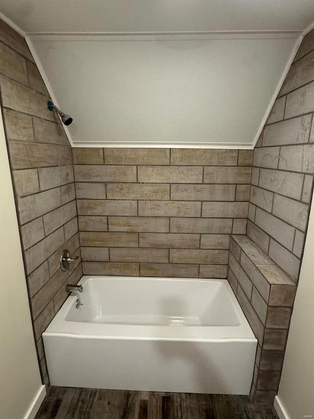 bathroom featuring tiled shower / bath, hardwood / wood-style flooring, and crown molding