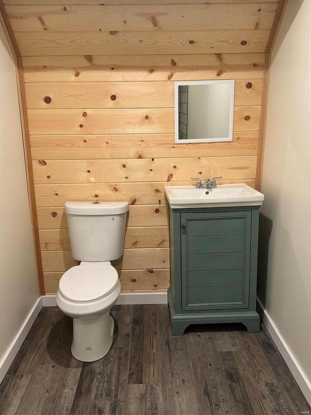 bathroom featuring hardwood / wood-style floors, wood walls, vanity, and wooden ceiling