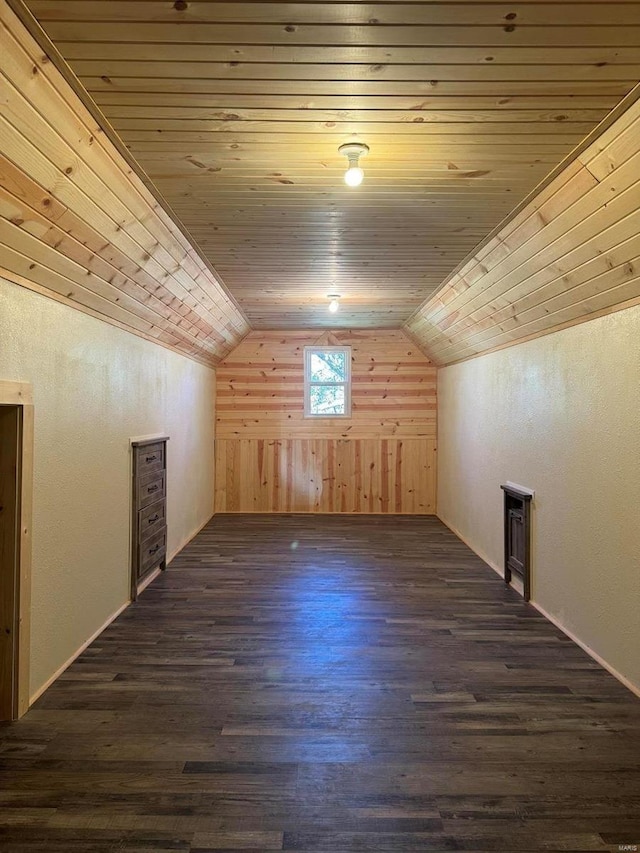 additional living space with wooden ceiling, dark hardwood / wood-style floors, wooden walls, and lofted ceiling