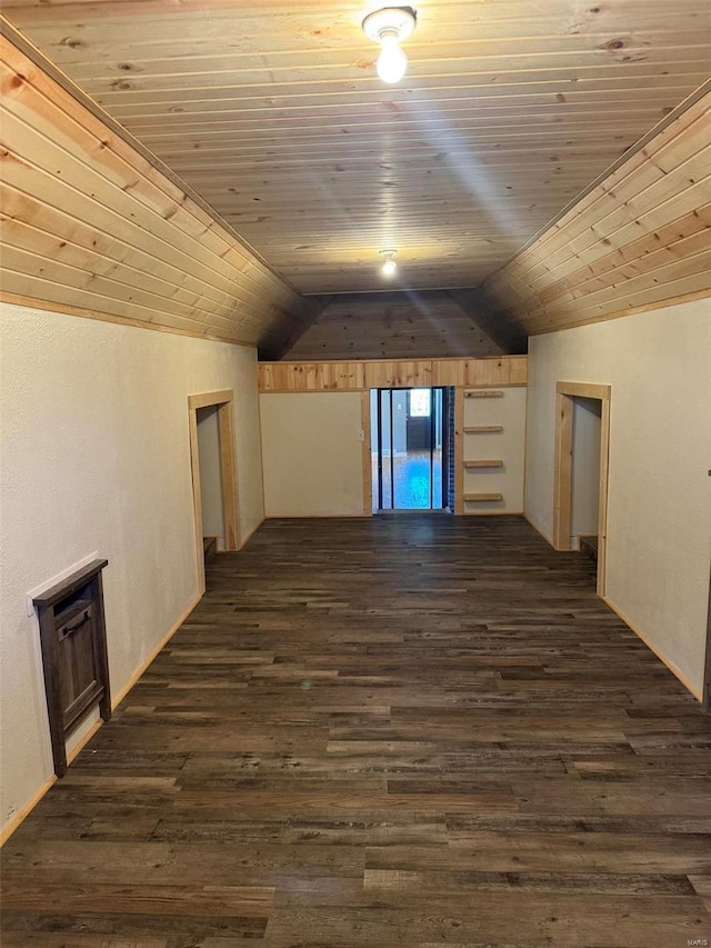 additional living space with dark wood-type flooring, lofted ceiling, and wood ceiling