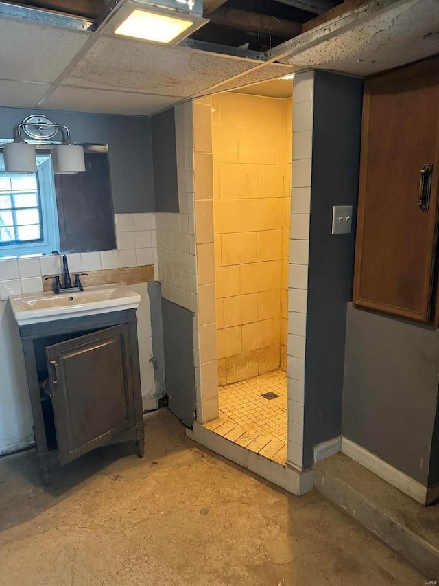 bathroom featuring concrete floors, sink, and walk in shower