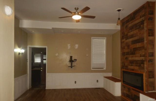 interior space with a fireplace, dark hardwood / wood-style floors, and ceiling fan