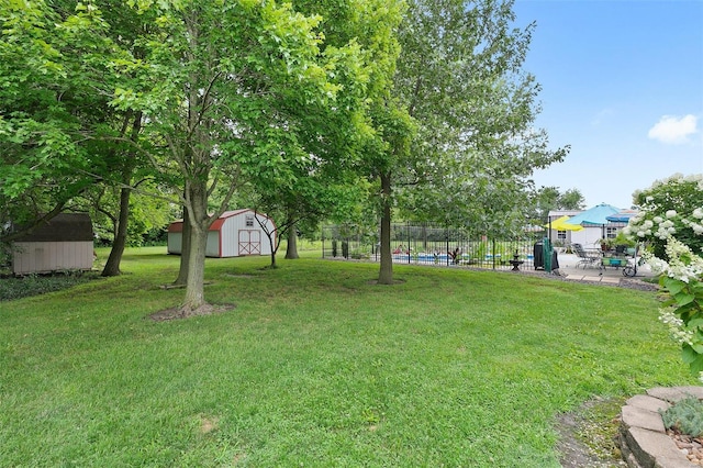 view of yard featuring a storage unit and a patio