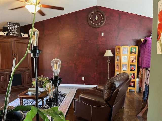 living room with dark wood-type flooring, ceiling fan, and vaulted ceiling