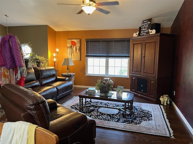 living room with dark wood-type flooring, ceiling fan, and vaulted ceiling