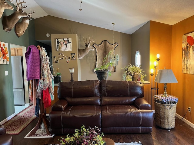 living room featuring dark hardwood / wood-style floors and vaulted ceiling