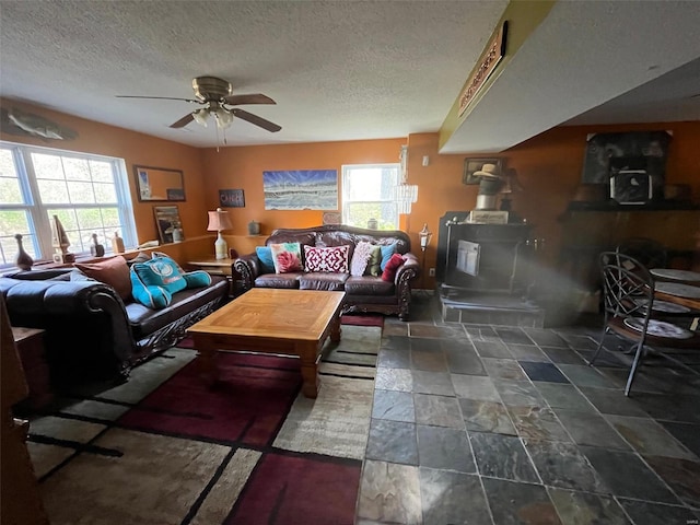 living room featuring a textured ceiling and ceiling fan