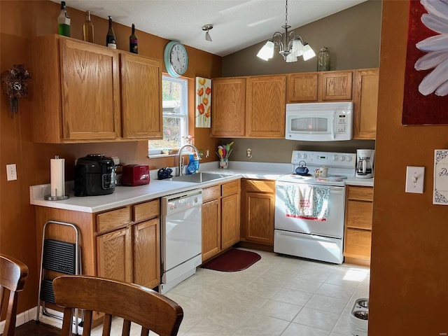 kitchen with sink, decorative light fixtures, white appliances, a chandelier, and vaulted ceiling