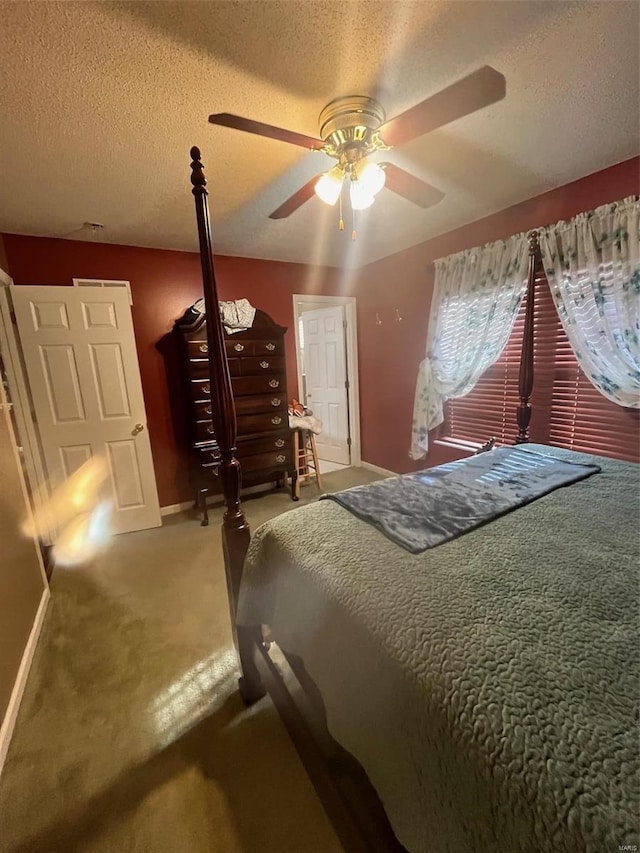 carpeted bedroom with a textured ceiling and ceiling fan