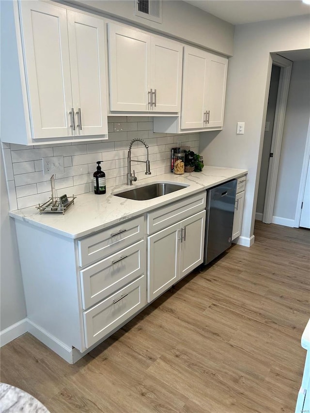 kitchen featuring dishwasher, white cabinets, light hardwood / wood-style flooring, and sink