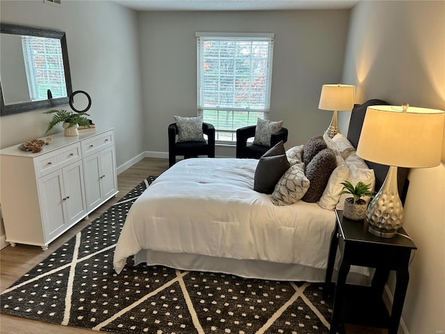 bedroom with hardwood / wood-style floors