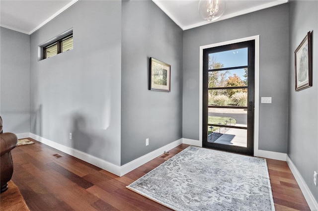 entrance foyer with wood-type flooring and ornamental molding