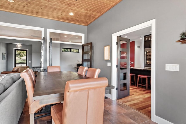 dining room with hardwood / wood-style flooring and wood ceiling