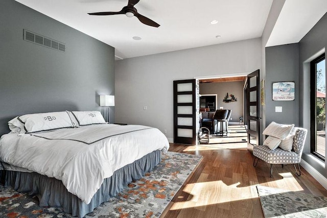 bedroom with french doors, wood-type flooring, and ceiling fan