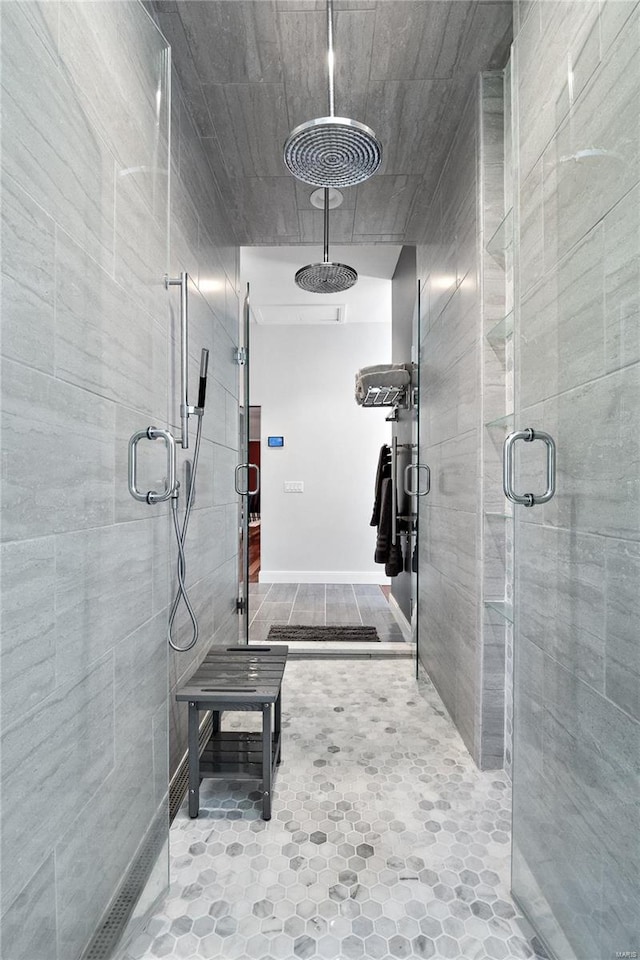 bathroom featuring a shower with door