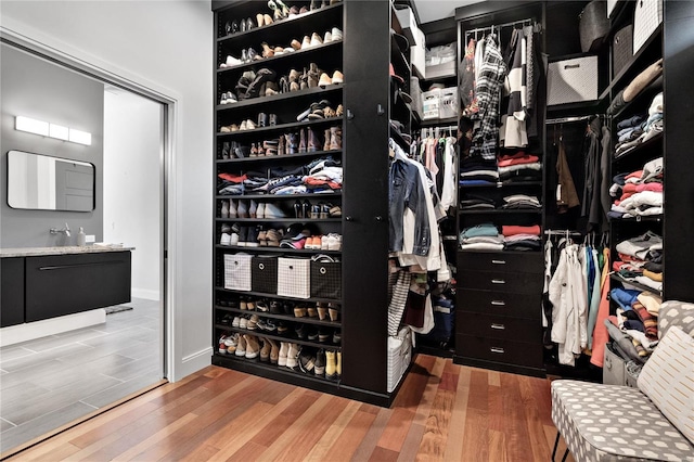 spacious closet featuring hardwood / wood-style flooring and sink