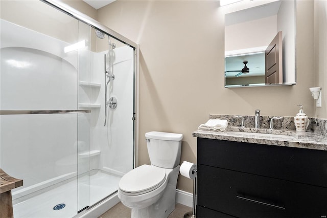 bathroom featuring walk in shower, ceiling fan, vanity, and toilet