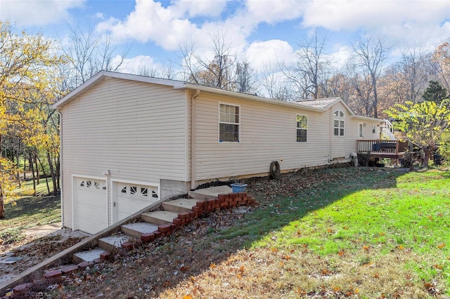 view of property exterior with a wooden deck, a yard, and a garage