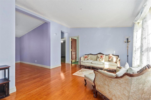 living room featuring a textured ceiling, hardwood / wood-style flooring, and a wealth of natural light