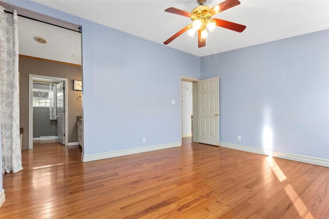 unfurnished room featuring hardwood / wood-style floors, a textured ceiling, and ceiling fan