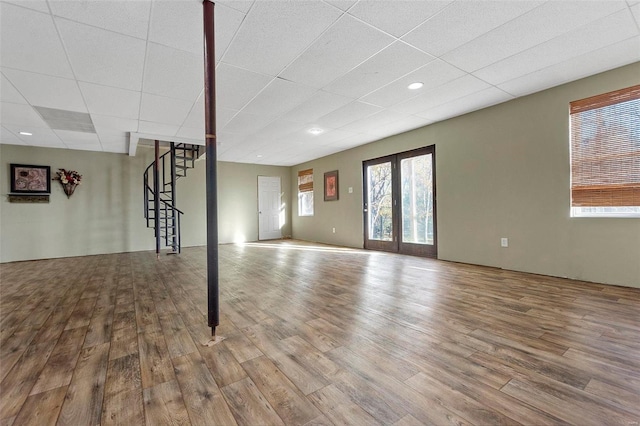 basement with wood-type flooring and french doors