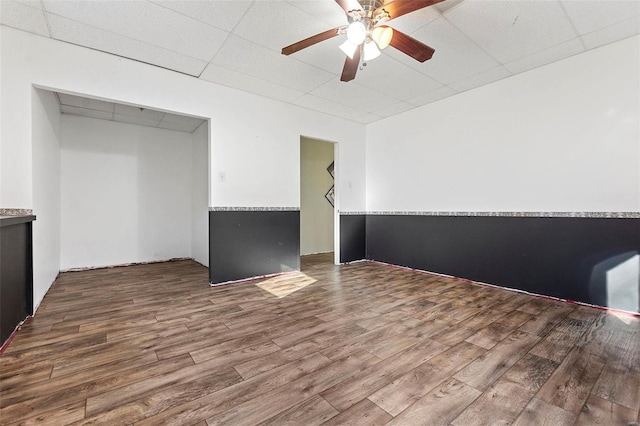 interior space with hardwood / wood-style floors, ceiling fan, a paneled ceiling, and a closet