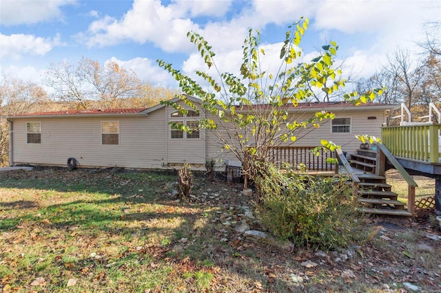 back of house with a lawn and a wooden deck