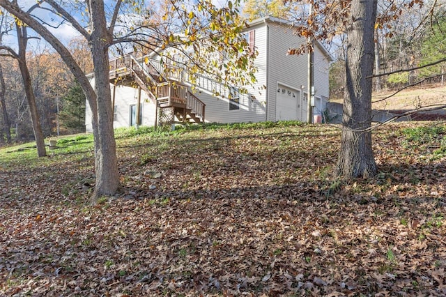 view of yard featuring a garage and a deck