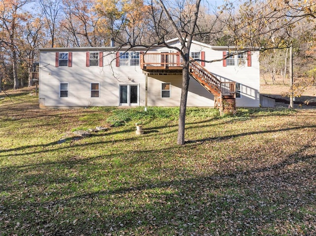 back of house featuring a lawn and a wooden deck