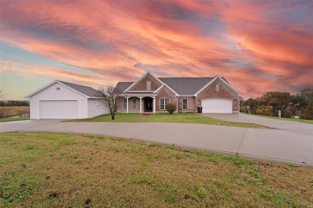 ranch-style home featuring a garage and a yard