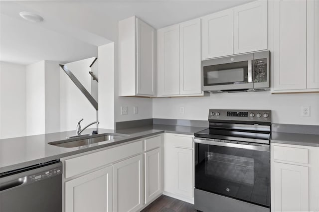 kitchen featuring white cabinetry, stainless steel appliances, sink, and dark hardwood / wood-style flooring