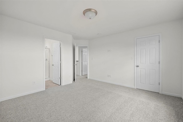 spare room featuring light carpet