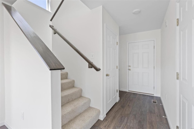 stairway featuring hardwood / wood-style flooring