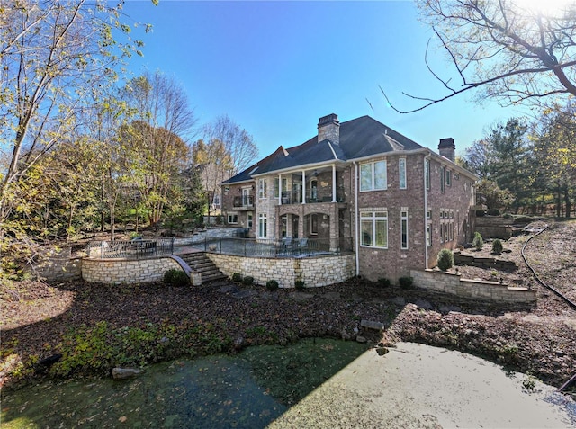 rear view of property with a balcony