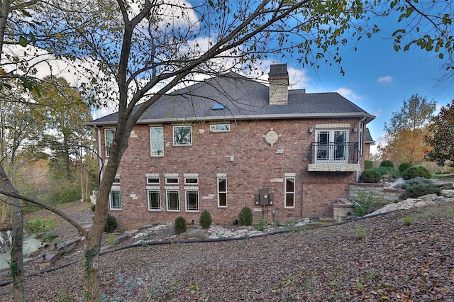 rear view of house featuring a balcony